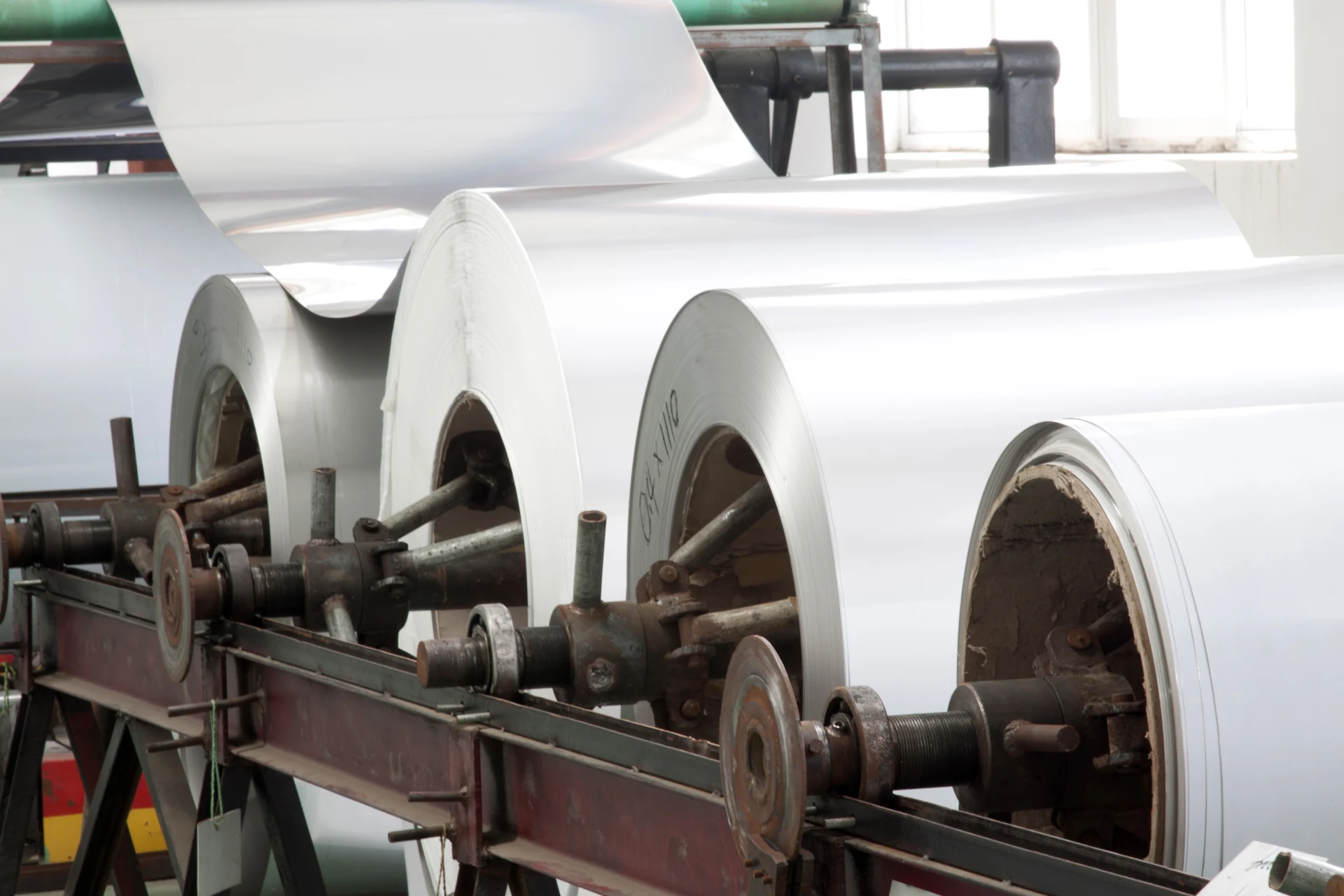 Aluminium sheet coils on industrial rolling machinery